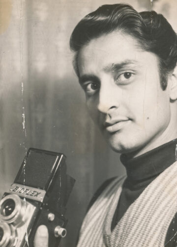 Satyavrat Jaswansingh Kshatriya holding a camera.