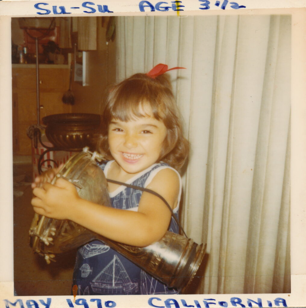 Three-year-old Suhaila with her father's drum.