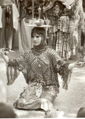 Meta, the original Bal Anat Tray dancer, weaing an assuit dress.